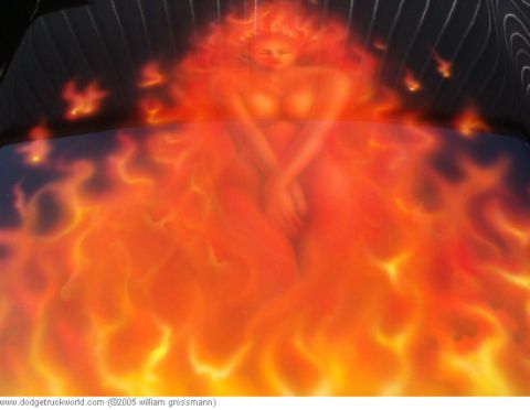 1985 Ford Bronco - Airbrushed flames and a woman adorn the hood of a vehicle, with a black background pinstripes.
