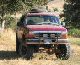 1991 Ford Explorer - This 1991 Ford Explorer is presented in a front-facing view, equipped with off-road tires and a protective bull bar.