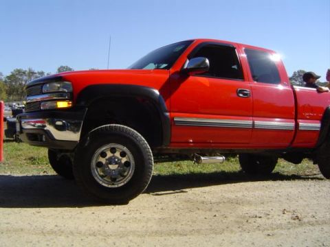 1979 Ford Bronco - A red pickup truck is parked outdoors under a clear blue sky.