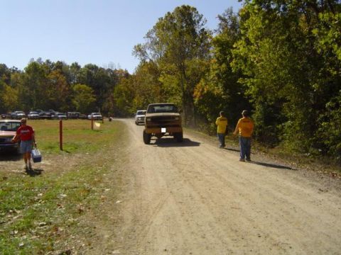 1979 Ford Bronco - A tan 1978 Ford Bronco is seen on a dirt road during an outdoor event.