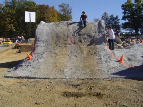 1979 Ford Bronco - An obstacle course is set up for a mud event, with children climbing on the structure.