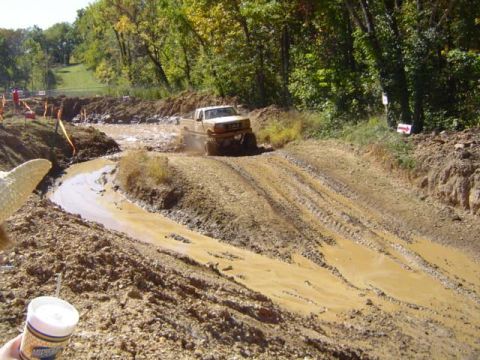 1979 Ford Bronco - A 1979 Ford Bronco navigates a challenging mud obstacle during an off-road event.
