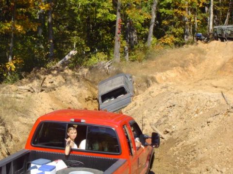 1979 Ford Bronco - Several vehicles navigate a challenging off-road course on a sunny day.