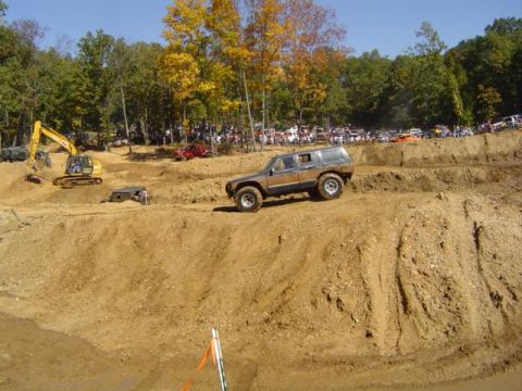 1979 Ford Bronco - An off-road event with multiple vehicles and spectators gathered on a sunny day.
