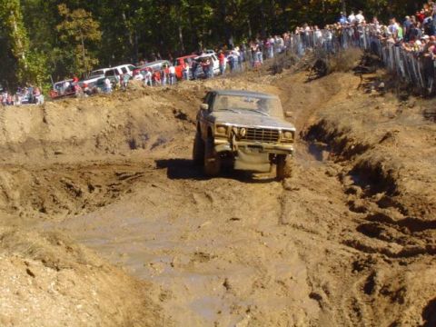 1979 Ford Bronco - A 1979 Ford Bronco tackles a challenging mud course during an off-road event.