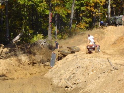 1979 Ford Bronco - Off-road vehicles navigate a challenging muddy terrain with one vehicle overturned.