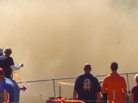 1979 Ford Bronco - A large dust cloud obscures the view at an outdoor event with spectators watching.