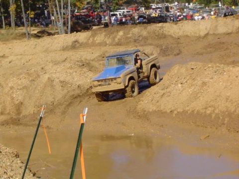 1979 Ford Bronco - A 1979 Ford Bronco navigates a muddy obstacle course during an off-road event.