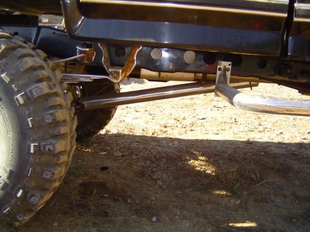 Close-up of a large tire and suspension components on a modified off-road vehicle