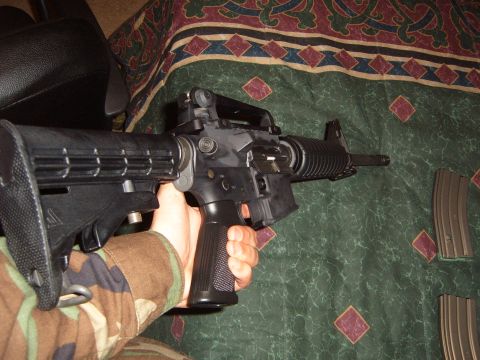 1988 Ford Bronco - A close-up view of an assault rifle, with two magazines visible in the background.