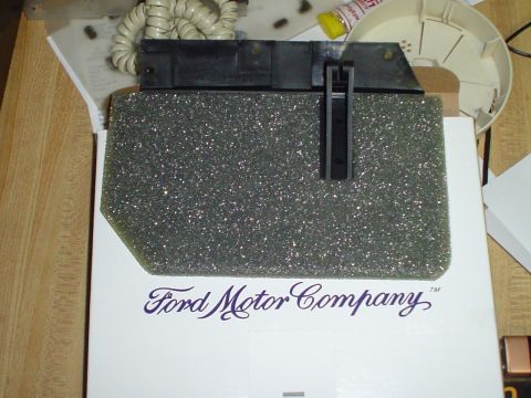 1984 Ford Bronco - Foam part with a Ford Motor Company box is shown. The part has a black clip.