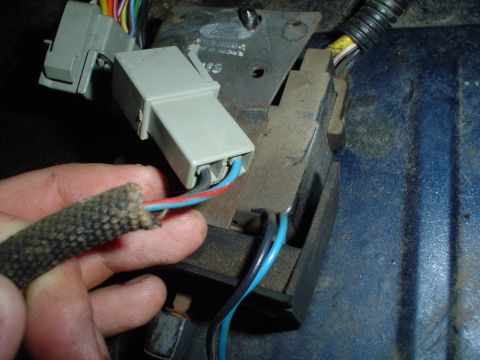 1984 Ford Bronco - Close-up of electrical connectors and wiring harness, with a Ford logo visible.