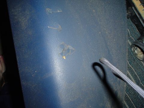 1984 Ford Bronco - Interior panel shows wear and tear, with visible damage and dust accumulation.