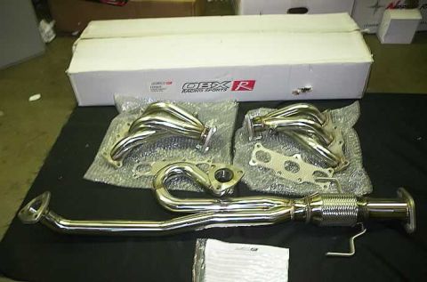 1994 Ford Probe - New exhaust components laid out on a black surface, with a branded box in the background.