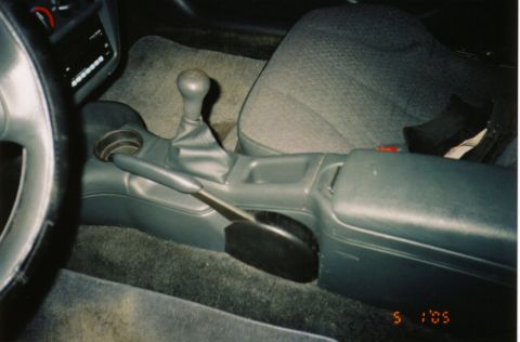 1996 Chevrolet Cavalier - The interior of a car is shown, focusing on the center console and manual transmission shifter.