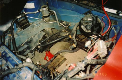 1996 Chevrolet Cavalier - Engine bay of a 1996 Chevrolet Cavalier, showing AC components and wiring harness.