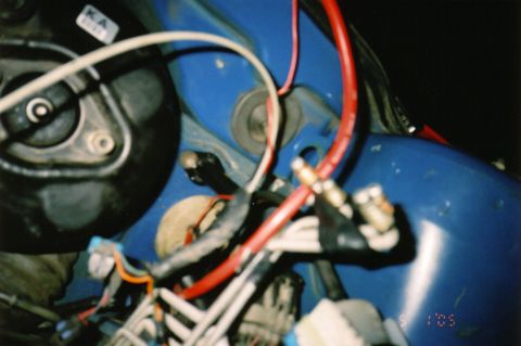 1996 Chevrolet Cavalier - This is a close-up view of the wiring harness in the engine bay, showing a complex network of wires.