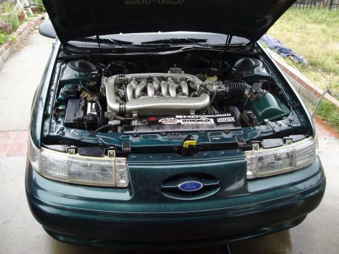 1993 Ford Taurus - Engine bay of a 1993 Ford Taurus SHO, showing the V6 engine and intake system.