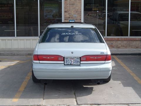 1994 Ford Thunderbird - Rear view of a silver 1992 Ford Thunderbird parked in a lot with a Kicker sticker on the rear window.