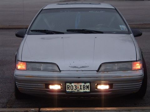 1994 Ford Thunderbird - Front view of a silver car with a hood ornament and Texas license plate.