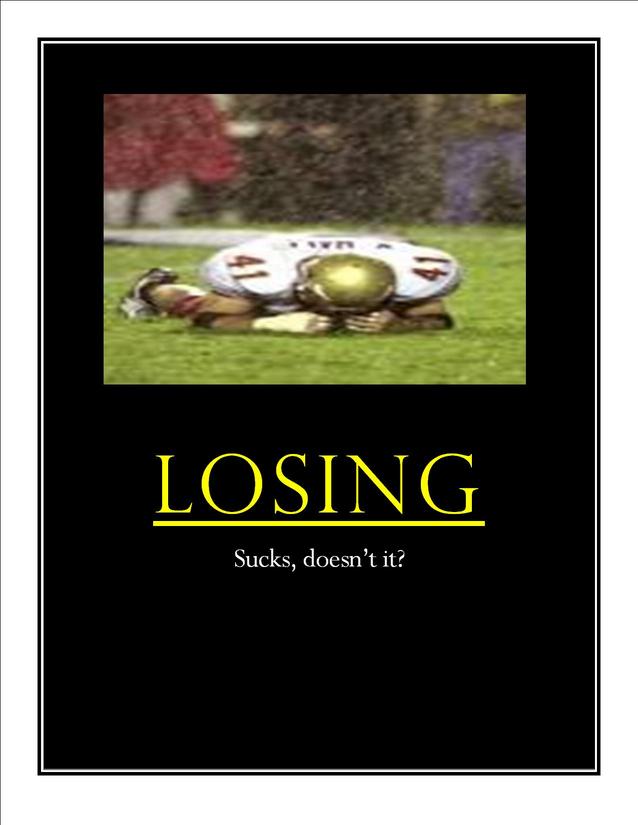 Football player in uniform lying on grass, text "LOSING Sucks, doesn't it?"