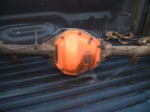 1989 Ford Bronco - A rear axle differential assembly is shown, resting in the bed of a pickup truck.