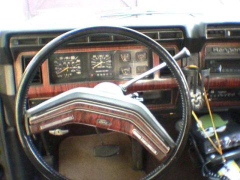 1981 Ford Bronco - Interior view of a 1981 Ford Bronco, woodgrain trim and the 'Ranger' badge on the dashboard.