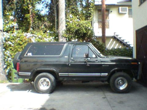 1981 Ford Bronco - Side view of a black Ford Bronco with a spare tire on the rear.