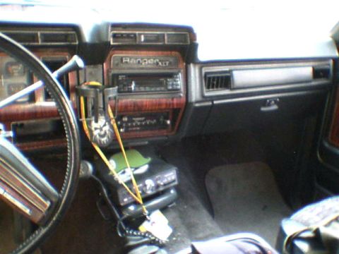 1981 Ford Bronco - Interior view of a 1981 Ford Bronco, showing the dashboard with wood-grain accents and a "Ranger XLT" badge.