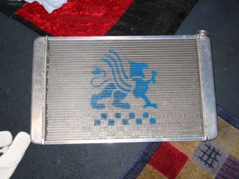 1985 Ford Crown Victoria LTD - Radiator with a blue griffin logo and checkered pattern is shown.
