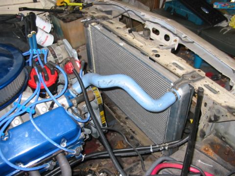 1985 Ford Crown Victoria LTD - Close-up view of an engine bay, showing the radiator and blue valve covers.