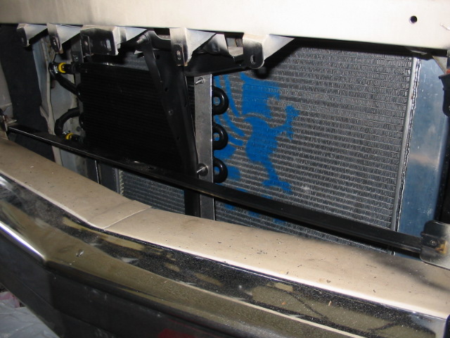 Engine oil cooler mounted in front of a radiator with a blue spray-painted figure