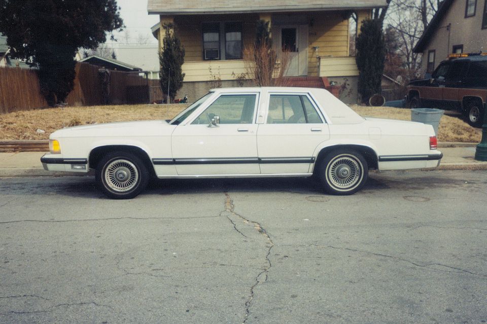 1991 Mercury Grand Marquis sedan, side view, parked on street