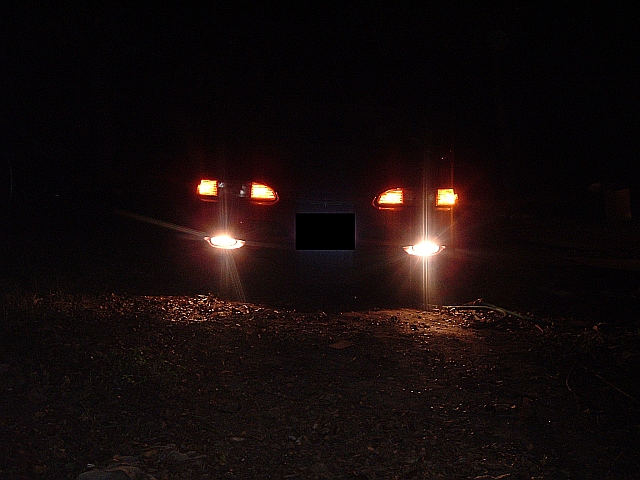 1994 Ford Thunderbird front view at night with headlights and turn signals illuminated