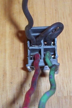 1978 Ford Mustang II - Electrical connector with multiple wires, likely a vehicle part, on a wooden surface.