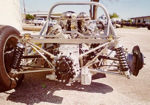 1997 Ford Crown Victoria - Exposed rear suspension and V8 engine of a custom-built vehicle, showing its chassis and roll cage.