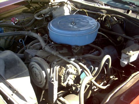 1972 Ford Ranchero - Close-up view of an engine bay, showing various mechanical parts and hoses under the hood.