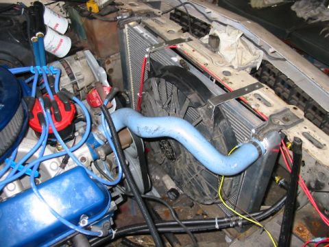 1985 Ford Crown Victoria LTD - Close-up of an engine bay, focusing on the radiator and cooling fan assembly.