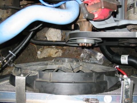 1985 Ford Crown Victoria LTD - The engine bay features a cooling fan, serpentine belt, and various hoses, with a visible part number on one hose.