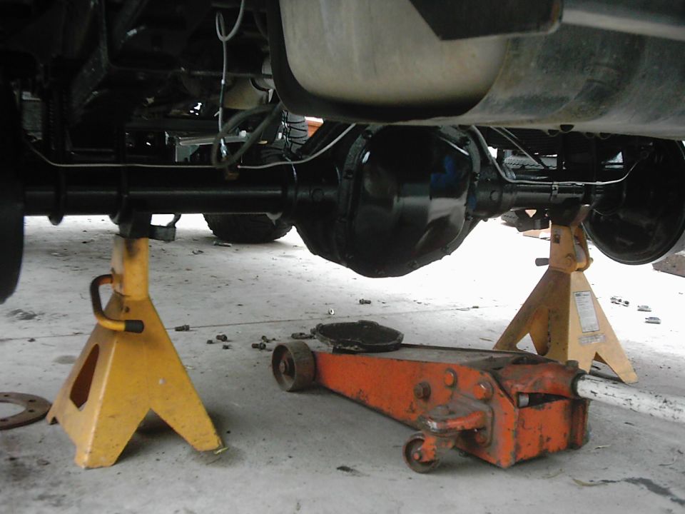 Rear axle and suspension on jack stands with a floor jack