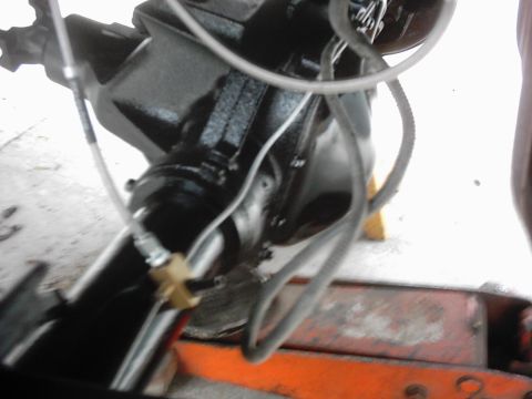 1978 Ford Bronco - Rear axle assembly with brake lines and hydraulic fittings, likely undergoing maintenance or repair.