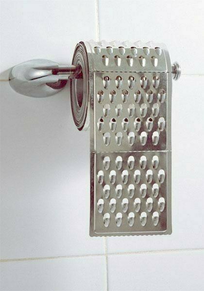 1967 Ford Ranchero - A novelty toilet paper holder designed to look like a kitchen grater is mounted on a tiled wall.