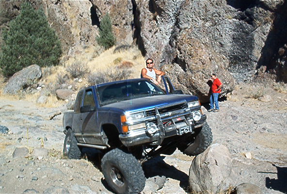 Blue pickup truck with winch on rocks, 1995 grille