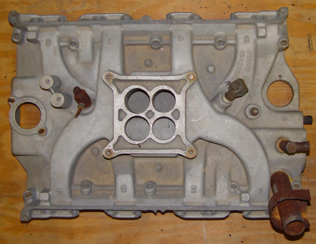 Aluminum intake manifold with four carburetor mounting holes and cast-in numbers