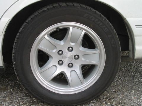 1996 Mercury Grand Marquis - Close-up of a silver alloy wheel with a black tire, showing the tread pattern and wheel design.