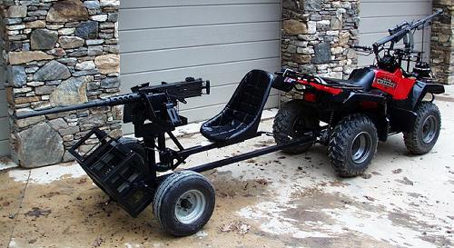 Red ATV with mounted machine gun and trailer