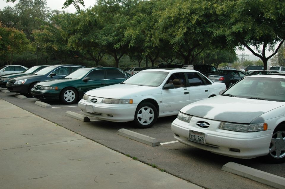 White 1991 Ford Taurus sedan with a license plate reading 3PIF369