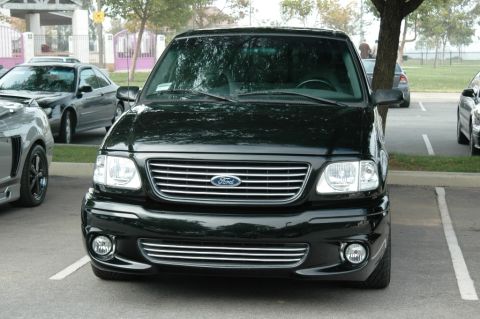 1991 Ford Taurus - Front view of a black Ford F-150 truck, likely from the 1999-2003 generation, parked in a lot.