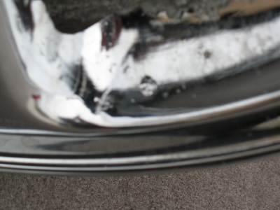 1999 Mitsubishi 3000GT - Chrome wheel rim detail, showing wear and tear. Supermotors.net logo visible.