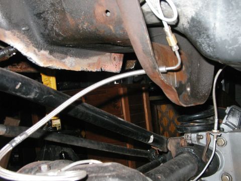 1994 Ford Bronco - Close-up view of the undercarriage, focusing on the frame and suspension system with visible rust.